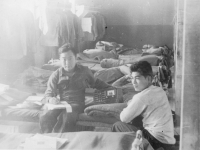 Taken on the morning of Sept 4, 1942 in the barracks - Camp McCoy, WIS. Sun-writing a letter - listening to the radio pictured with Pvt. N. Higa.  [Courtesy of John Oki]